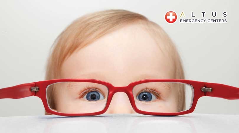 child in front of red eyeglasses