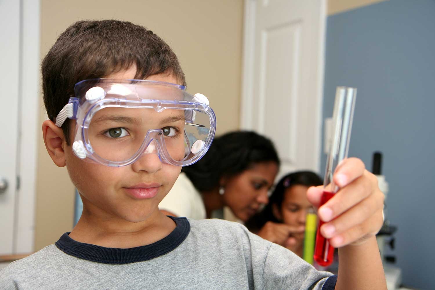 child wearing safety goggles in a science lab