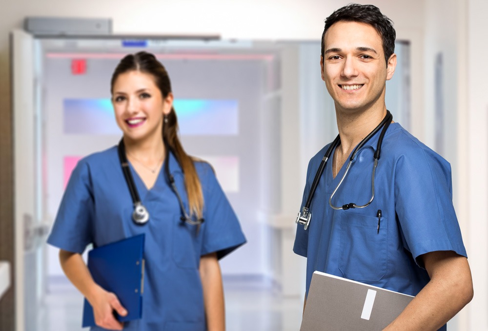 2 nurses in blue scrubs