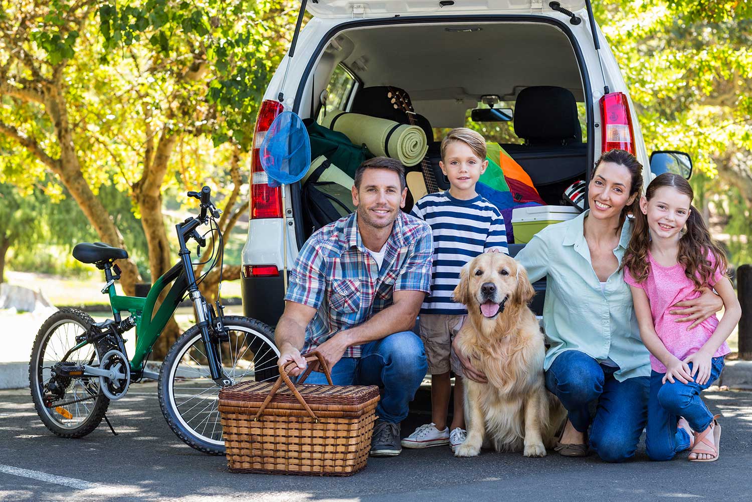 family of four and a pet dog with their outdoor gear