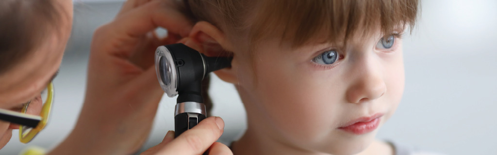 doctor examining a child's ear