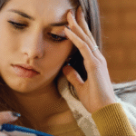 woman with flu symptoms including a headache
